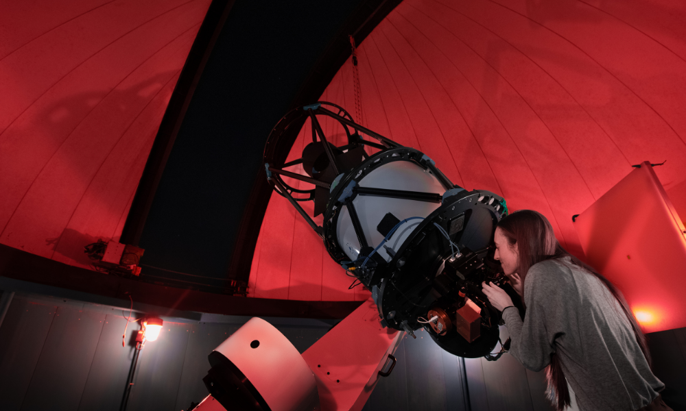 Person looks into the telescope in the Burke Gaffney Observatory