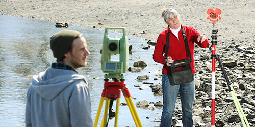 Two people working in the field.